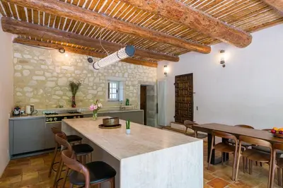 a kitchen and dining room with a table and chairs at Mas authentique à Eygalières in Eygalières