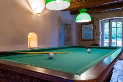 a pool table with pool balls and cuesticks on it at Mas authentique à Eygalières in Eygalières