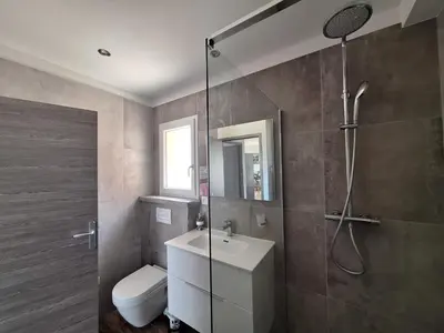 a bathroom with a shower and a sink and a toilet at Gîte l'olivier in Sainte-Tulle