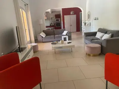a living room with a couch and a table at Villa spacieuse proche de Marseille avec jardin et piscine privée in La Tour-dʼAigues