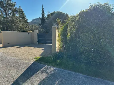 a gate in a driveway with a fence at Mazet des Cèdres au pied de la colline in Lagnes