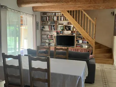 a living room with a couch and a tv at Mazet des Cèdres au pied de la colline in Lagnes