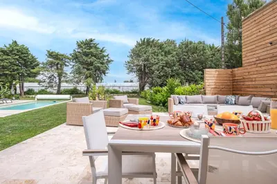 a patio with a table with food on it at Gîte Le Figuier des Alpilles- 6p in Eygalières