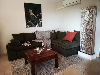 a living room with a couch and a coffee table at La Colline, villa avec piscine in Châteaurenard