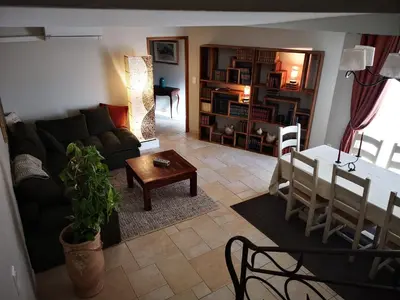 a living room with a couch and a table at La Colline, villa avec piscine in Châteaurenard