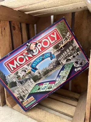 a magazine sitting on top of a wooden table at Oustau di Gaffo in LʼIsle-sur-la-Sorgue