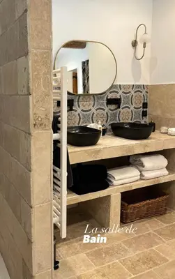 a bathroom with a sink and a mirror at Le Mas d'Emilienne in Coudoux