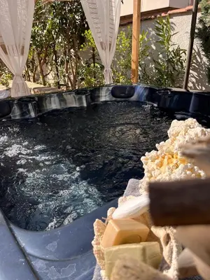 a hot tub with water and food in it at Le Mas d'Emilienne in Coudoux