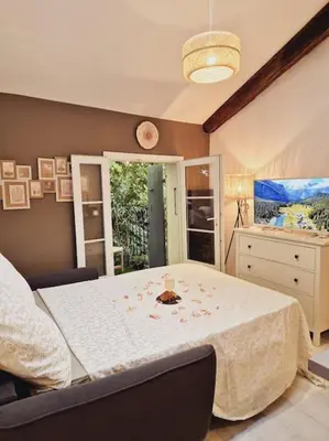 a bedroom with a table with a white table cloth at T2 Havre de paix nature cœur d Aix in Aix-en-Provence