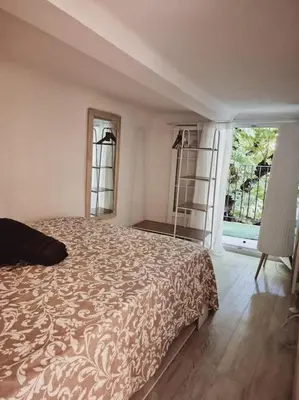 a bedroom with a bed and a large window at T2 Havre de paix nature cœur d Aix in Aix-en-Provence