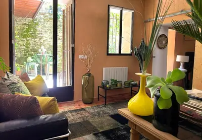 a living room with vases sitting on a table at La Cigalou - Bonnieux Centre in Bonnieux
