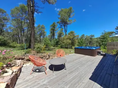a patio with a table and chairs and a hot tub at La Pinède de Venelles Jacuzzi privatif in Venelles