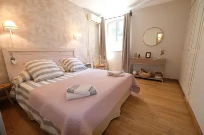 a bedroom with a bed with two towels on it at Charming Provencal Mas with pool by Taillades, close to Cavaillon in the Luberon, sleeps 6. in Les Taillades