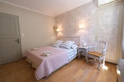 a bedroom with a bed and a table and a chair at Charming Provencal Mas with pool by Taillades, close to Cavaillon in the Luberon, sleeps 6. in Les Taillades