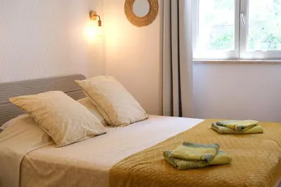 a bedroom with a bed with two towels on it at Charming Provencal Mas with pool by Taillades, close to Cavaillon in the Luberon, sleeps 6. in Les Taillades