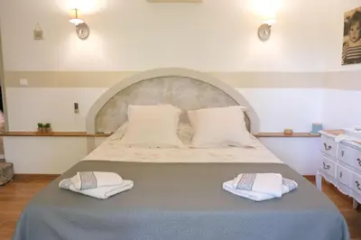 a bedroom with a bed with two towels on it at Charming Provencal Mas with pool by Taillades, close to Cavaillon in the Luberon, sleeps 6. in Les Taillades