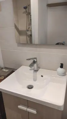 a bathroom with a white sink and a mirror at Au Petit Luberon in Cheval-Blanc