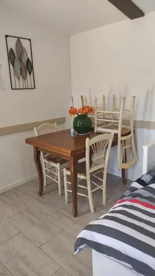 a dining room with a wooden table and chairs at Au Petit Luberon in Cheval-Blanc