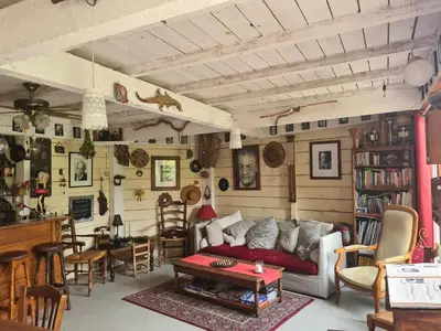 a living room with a couch and a table at Le Mazet des Beaujots in Monteux