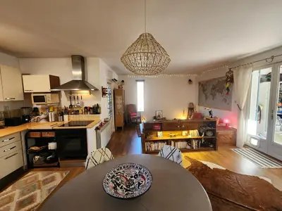 a kitchen with a table in the middle of a room at Le Mazet des Beaujots in Monteux