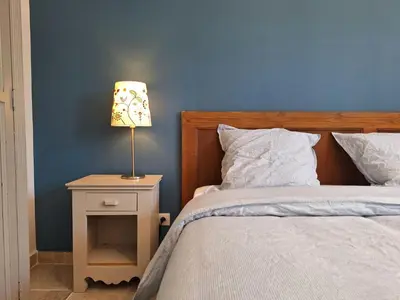 a bedroom with a bed and a lamp on a night stand at Mas Les Figuières in Monteux