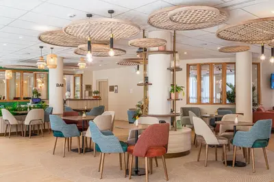 a waiting room with tables and chairs at DOMITYS - L'Amandier in Aix-en-Provence