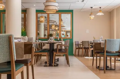 a dining room with a table and chairs at DOMITYS - L'Amandier in Aix-en-Provence