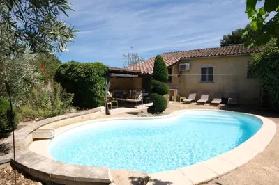 a swimming pool in front of a house at Air-conditioned house with heated pool, Luberon, in Maubec – 6 people in Maubec