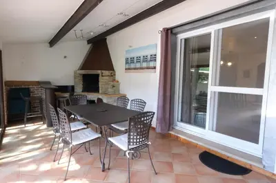a dining room with a table and chairs and a large window at Air-conditioned house with heated pool, Luberon, in Maubec – 6 people in Maubec