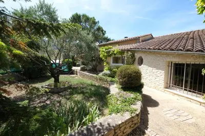 a house with a garden in front of it at Air-conditioned house with heated pool, Luberon, in Maubec – 6 people in Maubec