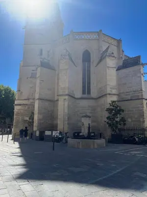 a large stone building with a clock tower at Logement studio avec vue sur le centre Historique in LʼIsle-sur-la-Sorgue