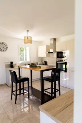 a kitchen with a table and some chairs in it at La Villa Sable en Provence in Saint-Saturnin-les-Apt