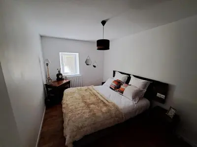 a bedroom with a large bed and a window at Bastide de la Couloubre in Mallemort