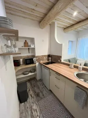 a kitchen with a sink and a counter top at Le cocon d Elsa in LʼIsle-sur-la-Sorgue