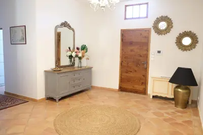 a room with a mirror and a dresser with flowers on it at superb prestige property with indoor heated swimming pool, seminar room and tennis court in mouries, in the alpilles in provence – 16 people in Mouriès