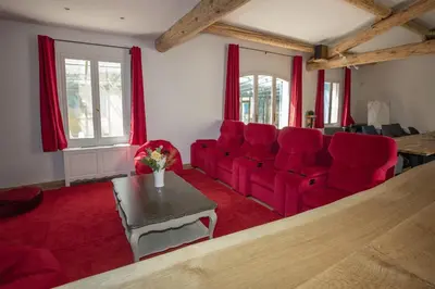 a living room with a red couch and red chairs at superb prestige property with indoor heated swimming pool, seminar room and tennis court in mouries, in the alpilles in provence – 16 people in Mouriès