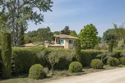 a house in the middle of a garden with bushes at superb prestige property with indoor heated swimming pool, seminar room and tennis court in mouries, in the alpilles in provence – 16 people in Mouriès