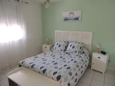 a bedroom with a bed and two night stands at Villa au calme in Eyguières