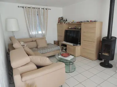 a living room with a couch and a tv at Villa au calme in Eyguières