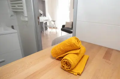 a yellow towel sitting on top of a kitchen table at Le Partage des eaux - 4 couchages - Hypercentre - Clim - Wifi in LʼIsle-sur-la-Sorgue