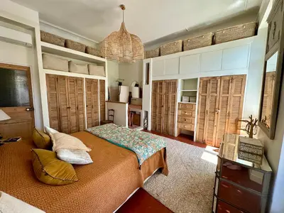a bedroom with a bed and a chandelier at Divine Idylle Luxe 3 chambres, terrasse 130m2, jacuzzi, Clim 5 m Cours Mirabeau in Aix-en-Provence