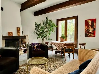 a living room filled with furniture and a table at L' Escale in Bonnieux
