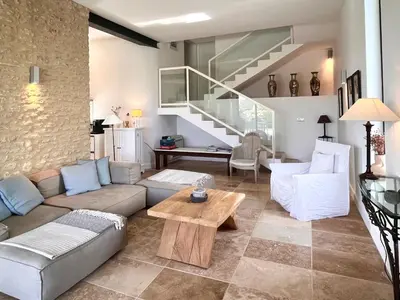 a living room with a couch and a table at Le Clos de Yann in Gordes