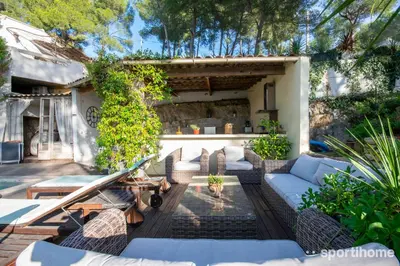 a patio with a couch and a table at Villa Le Mas des Roches à 15mn airport Marseille in Velaux