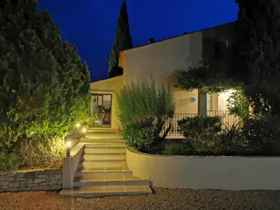 a house with stairs in front of it at night at Juste en Provence in Saint-Saturnin-les-Apt