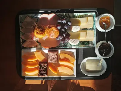 a tray filled with different types of cheese and fruit at Juste en Provence in Saint-Saturnin-les-Apt
