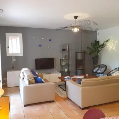 a living room with two couches and a tv at les couleurs du sud in Aix-en-Provence