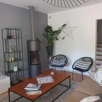 a living room with a coffee table and a fireplace at les couleurs du sud in Aix-en-Provence