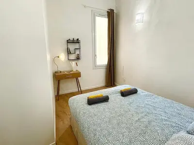 a bedroom with a bed with two pillows on it at T2 Cosy - Place des Cardeurs in Aix-en-Provence