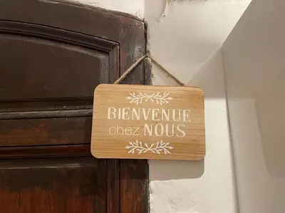 a wooden sign on a door with the words benevolent cheernox at T2 Cosy - Place des Cardeurs in Aix-en-Provence
